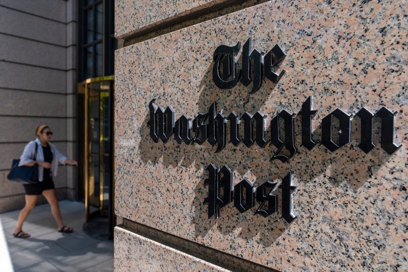 FILE - A person walks into the One Franklin Square Building, home of The Washington Post newspaper, June 21, 2024, in Washington.