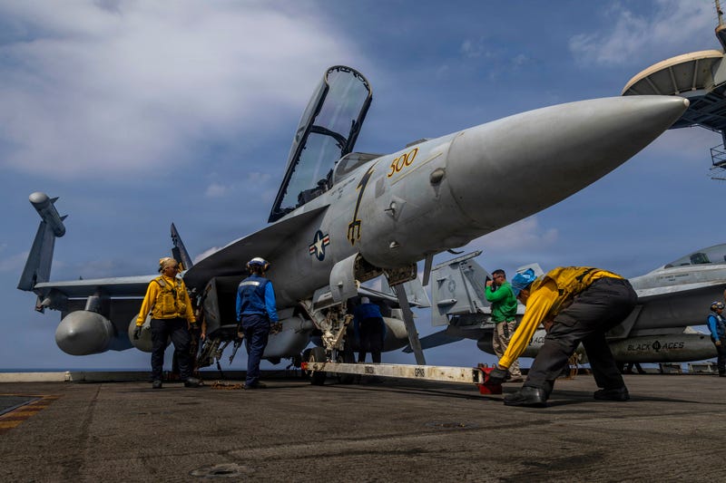 This photo provided by the U.S. Navy shows sailors preparing a Boeing EA-18G Growler on the flight deck of the Nimitz-class aircraft carrier USS Abraham Lincoln in the Indian Ocean on Jan. 21, 2026.