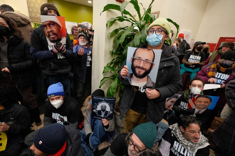 Protesters stage a sit-in in the lobby of a Hilton Garden Inn in New York, Tuesday, Jan. 27, 2026