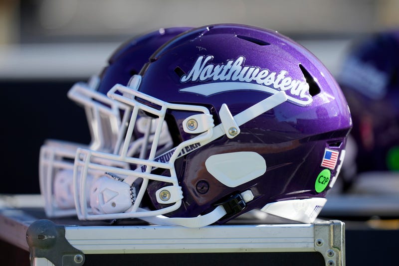 FILE - A Northwestern helmet is seen on the bench before an NCAA college football game against Iowa, Oct. 26, 2024, in Iowa City, Iowa. 