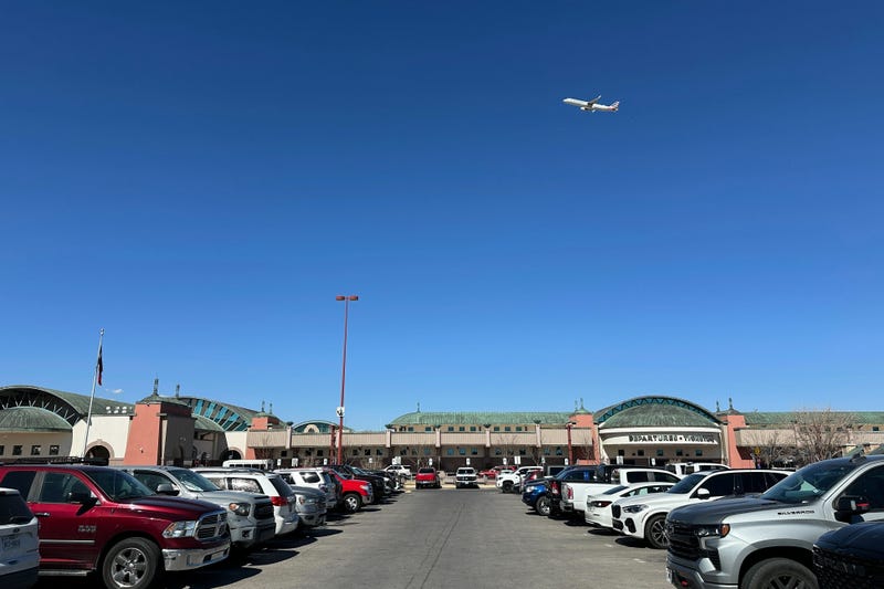 A plane flies over El Paso International Airport, Wednesday, Feb. 11, 2026, in El Paso, Texas