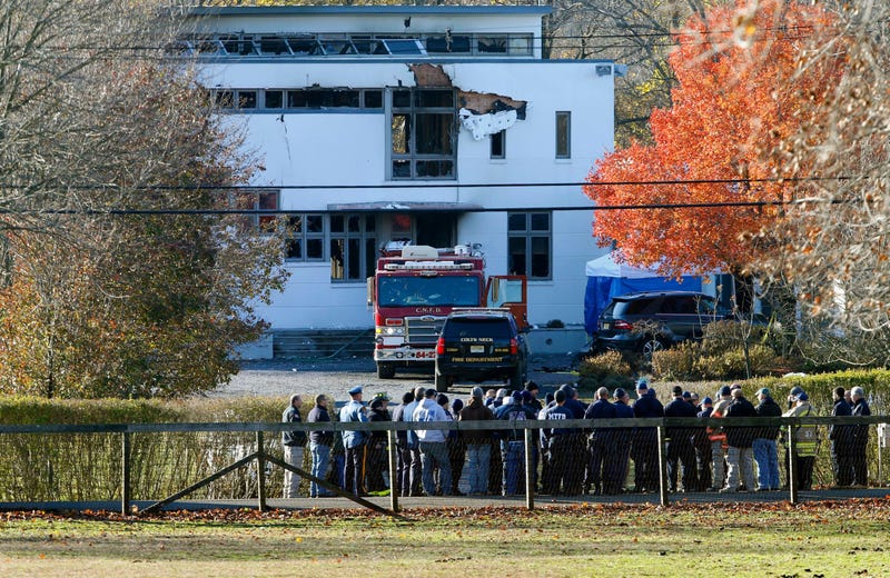 In this Nov. 21, 2018 file photo, authorities gather in Colts Neck, N.J., to investigate the aftermath of fatal fire