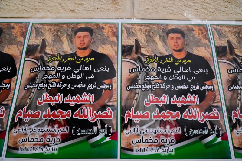 Posters with the name and picture of Palestinian-American Nasrallah Muhammad Jamal Abu Siyam, 19, who according to the Palestinian Health Ministry was shot by settlers on Wednesday night, are seen during his funeral in the West Bank village of Mukhmas, east of Ramallah, Thursday, Feb. 19, 2026. 