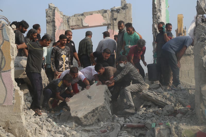 Rescue workers and residents search through the rubble in the aftermath of a strike on a girls' elementary school in Minab, Iran, Saturday, Feb. 28, 2026.