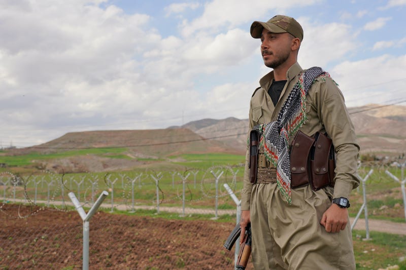 Member of the Democratic Party of Iranian Kurdistan PDKI stands at a checkpoint leading to their base in Koya district of Irbil, Iraq, Friday, Feb. 27, 2026.