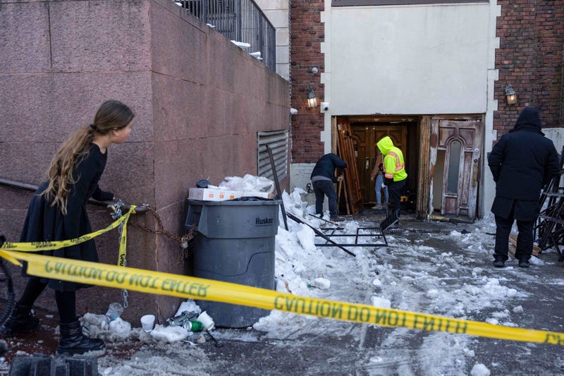 A person watches the scene where a car slammed into the entrance of the Chabad Lubavitch world headquarters, Jan. 29, 2026, in New York. 