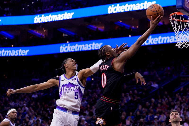 Philadelphia 76ers' Tyrese Maxey, right, goes up for the lay-up against Utah Jazz's Cody Williams, left, during the first half of an NBA basketball game, Wednesday, March 4, 2026, in Philadelphia. 