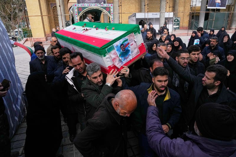The coffin of Mehdi Hosseini, a man killed in a U.S.-Israeli strike, is carried for burial at Behesht-e Zahra cemetery in Tehran, Iran, Monday, March 9, 2026.