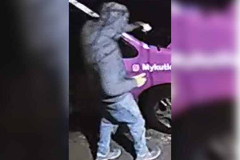 Surveillance video shows a man pouring what appears to be a flammable substance on the windshield of an SUV
