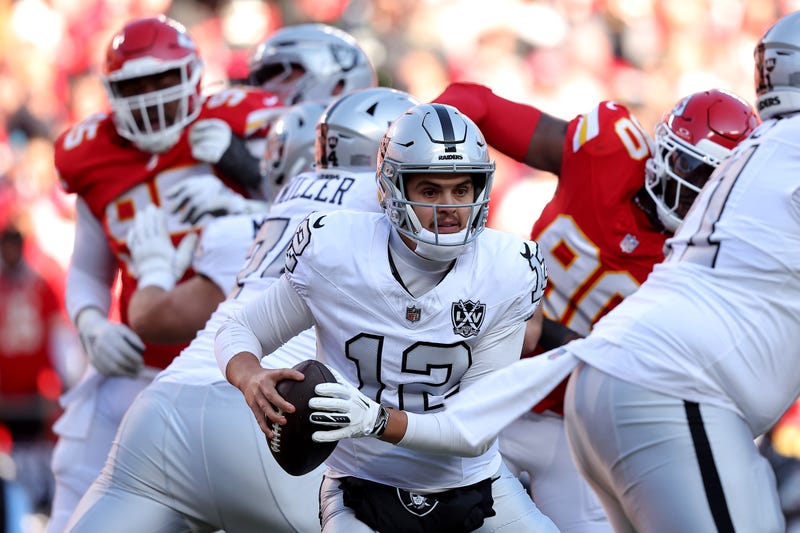 Aidan O'Connell #12 of the Las Vegas Raiders scrambles under pressure against the Kansas City Chiefs during the first quarter in the game at GEHA Field at Arrowhead Stadium on November 29, 2024 in Kansas City, Missouri.
