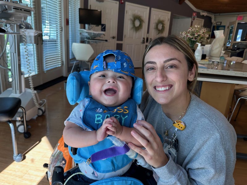 A certified nurse with Almost Home Kids poses for a photo with Aiden, one of nearly 2,500 children who have been helped by the organization.