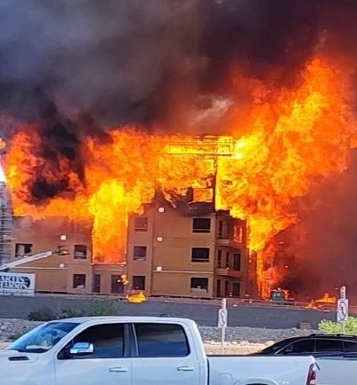 Fire burns at an under-construction apartment complex on June 21, 2023
