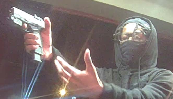 Surveillance footage of an armed robbery suspect taken 3-10-25.