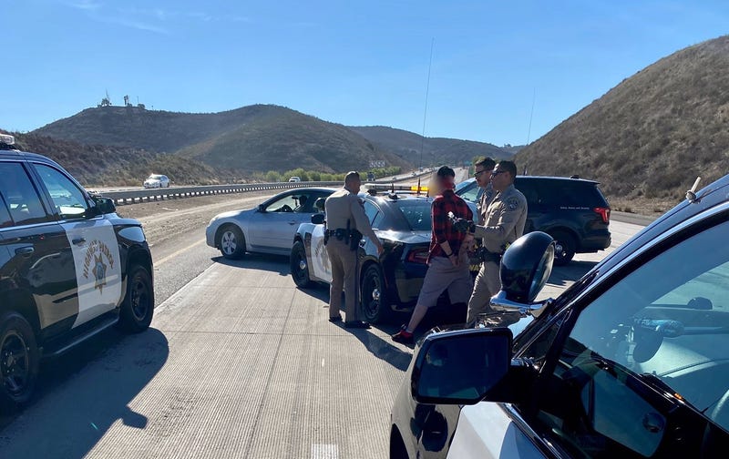 CHP officers arresting driver following a pursuit from San Fernando Valley to Ventura County.