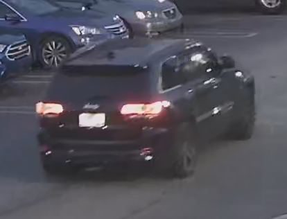 Snapshot of suspects' vehicle, a black colored Jeep Cherokee with chrome trim around rear passenger windows