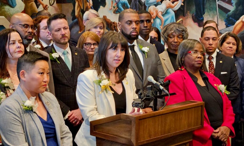 House Minority Leader Ashley Aune of Kansas City, surrounded by members of the Democratic caucus, speaks at news conference after the 2025 legislative session opened