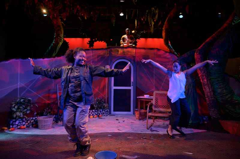 Foreground: Cianna Castro (Camilla Marie) and Taysha Marie Canales (Maria Soledad), background: Anssumane Silla (Percussion).