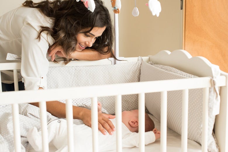 Mom with baby in crib