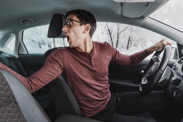 Guy backing up car