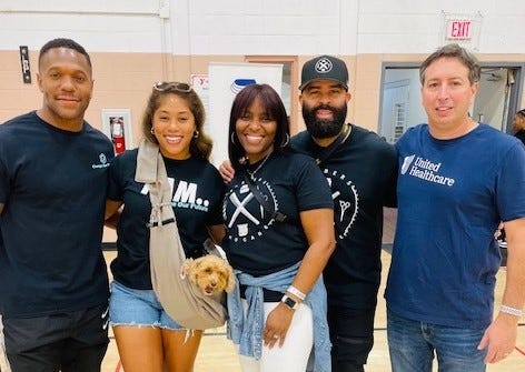 Rodney and Erica McLeod (left) and Barbers Who Care co-founder Kenny Duncan (second from right) at the 14th Annual Barbers Who Care Back-to-School Giveback