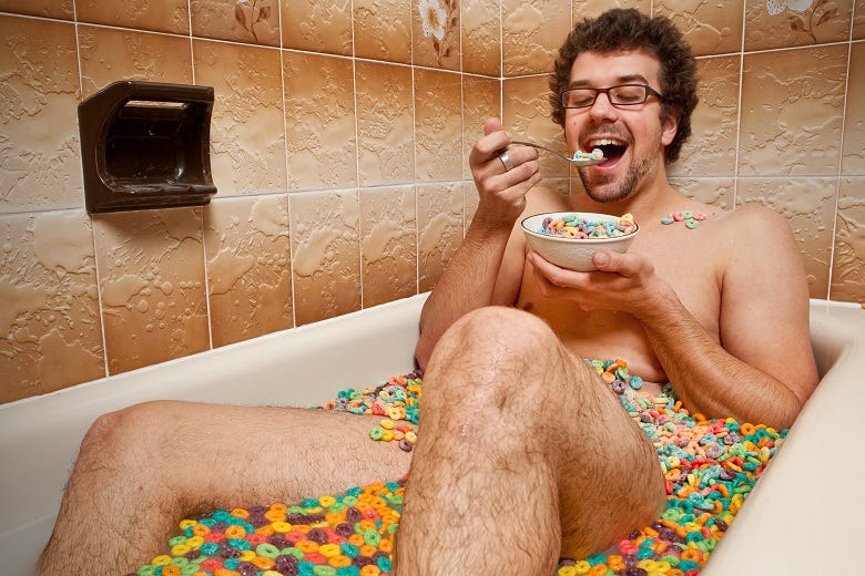 man eating cereal in bathtub