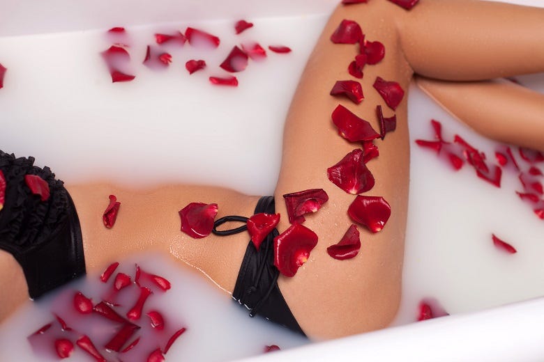 woman in bathtub with heart shaped petals