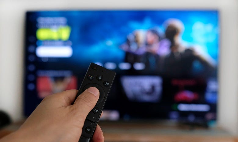 holding TV remote