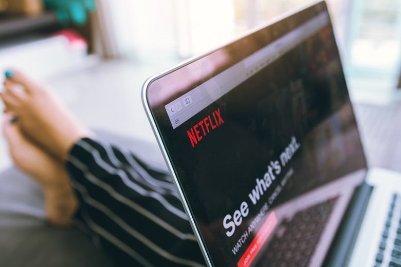 Woman streaming TV on laptop