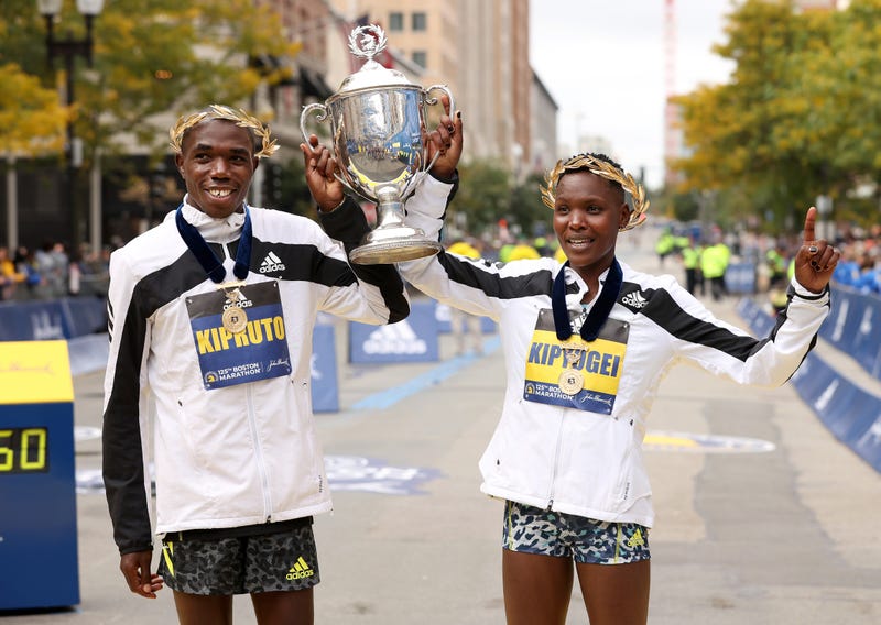Benson Kipruto and Diana Kipyogei of Kenya react after winning the men's and women's divisions of the 125th Boston Marathon on October 11, 2021 in Boston, Massachusetts.