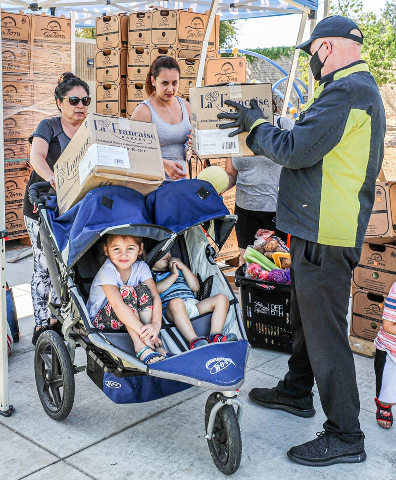 KNX Hero giving food to family