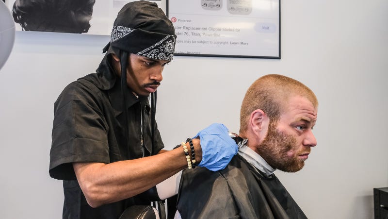 Sharif Bland gives a customer a trim at Generations Barber Academy.