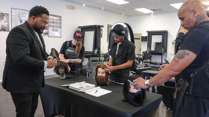 Tyce Combs is shown with Genevieve Blankley, Sharif Bland and Corey Blackwell at Generations Barber Academy.