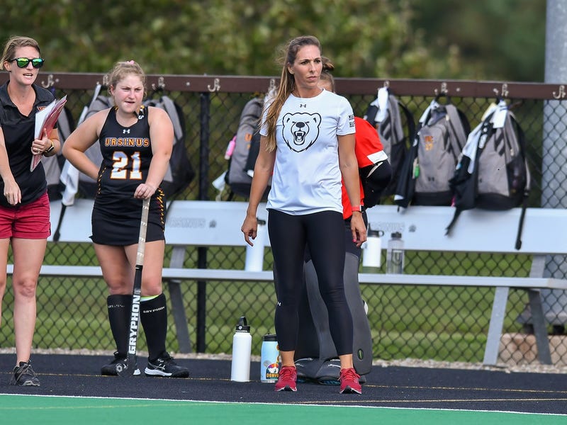 Janelle Benner (right) watches from the sidelines as head field hockey coach at Ursinus College.