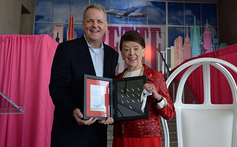 Chairman and CEO Doug Parker presents Bette Nash with a complete set of American Airlines anniversary pins for years 1-60.