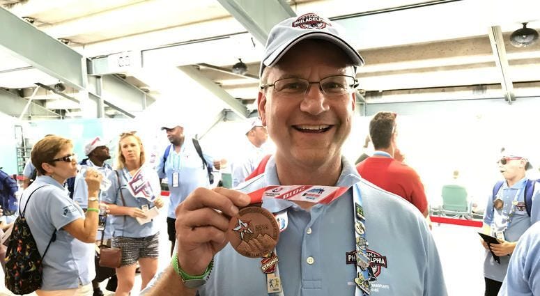 Bill Soloway holds up a medal at the 2018 Transplant Games of America in Salt Lake City.