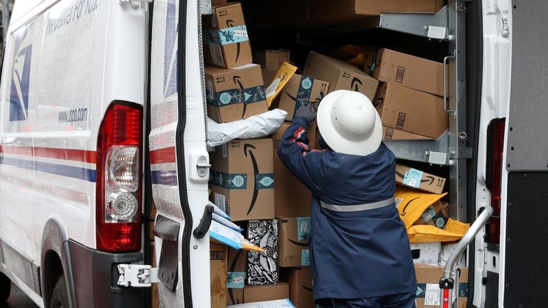 A U.S. Postal Service (U.S.P.S.) worker unpacks packages from a truck on December 02, 2019 in San Francisco, California. 