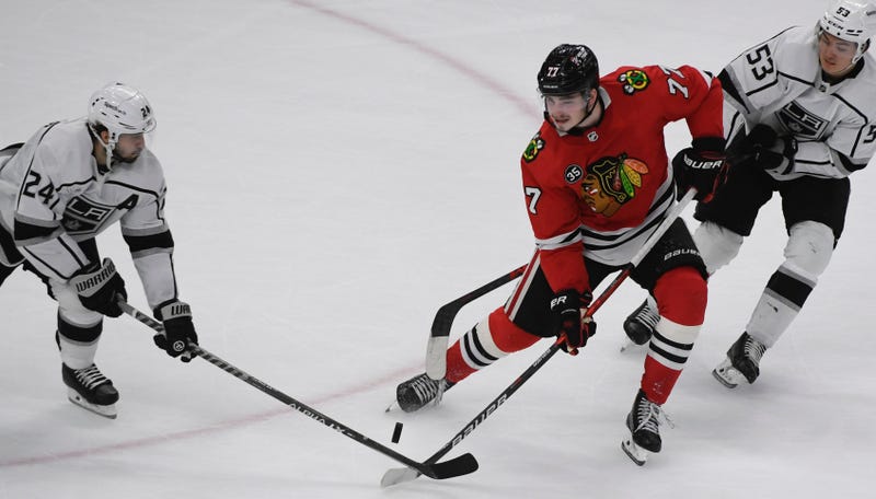 Blackhawks center Kirby Dach (77) fights for the puck with Kings center Phillip Danault (24) and defenseman Jordan Spence (53).