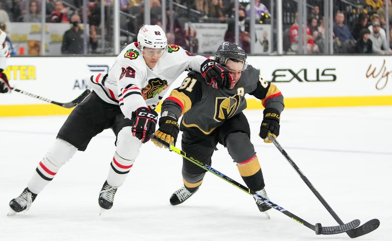 Blackhawks defenseman Caleb Jones (82) intercepts the puck from Vegas Golden Knights center Marchessault (81).