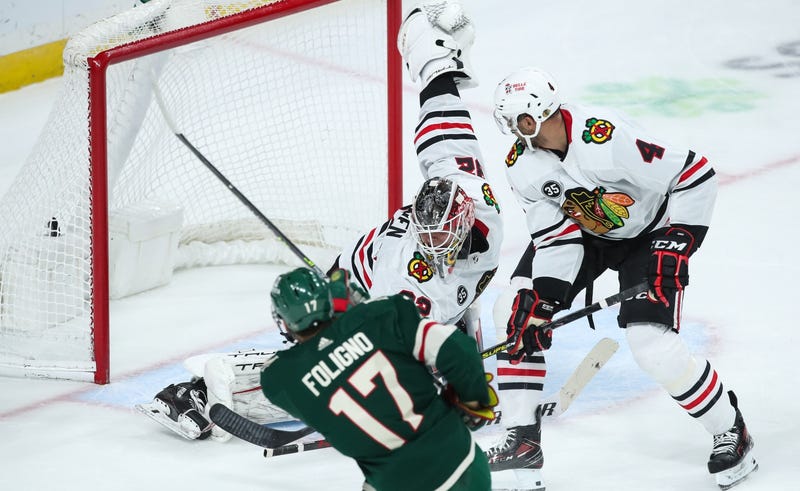 Wild left wing Marcus Foligno (17) scores a goal against Blackhawks goaltender Kevin Lankinen (32) in overtime.