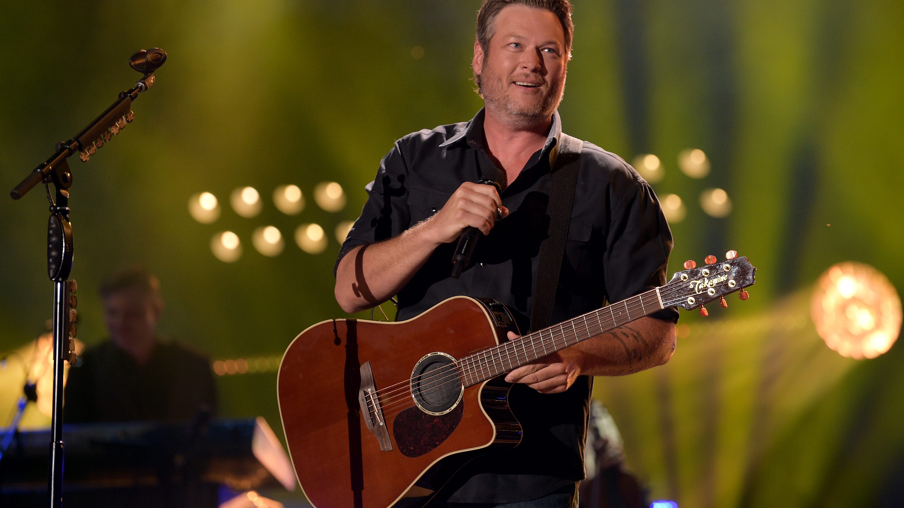 Blake Shelton Kisses a Gwen Stefani Album Cover on Stage