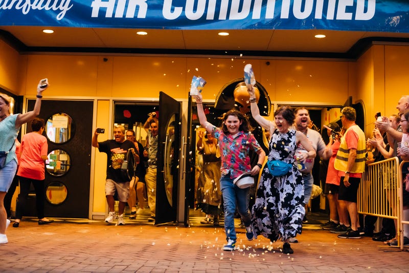 Fans run out of the Colonial Theatre in Phoenixville to reenact a key scene from "The Blob" at Blobfest 2023.