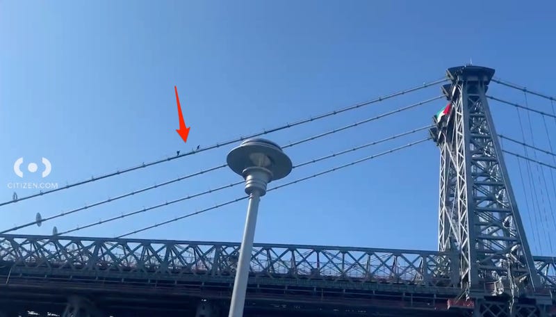 Two people, believed to be members of the NYPD, were seen heading up to the flag during the morning rush
