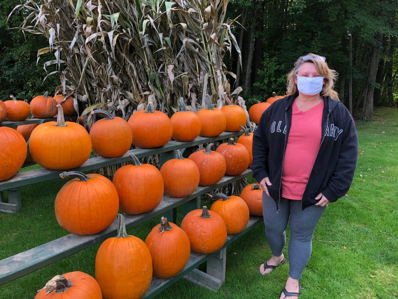 Bridgid Hinman next to some of the pumpkins at her pumpkin stand in South Abbott Road in Orchard Park