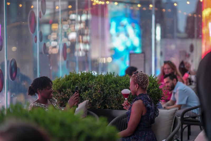 Attendees enjoying drinks at “Bubbles Over Broadway” at The Perch, on the eighth floor of the New York Marriott Marquis.