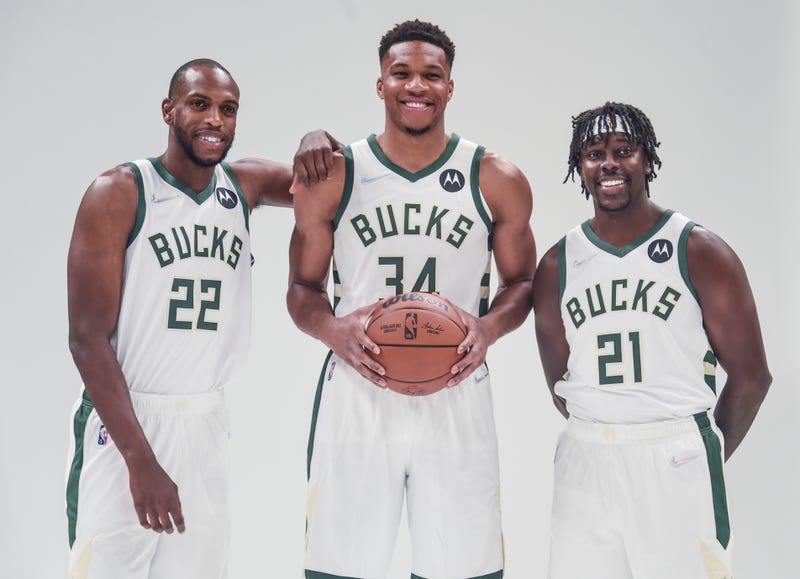 Sep 27, 2021; Milwaukee, WI, USA; Milwaukee Bucks forward Khris Middleton (22) and forward Giannis Antetokounmpo (34) and guard Jrue Holiday (21) pose for pictures during Media Day at the Fiserv Forum. Mandatory Credit: Benny Sieu-USA TODAY Sports