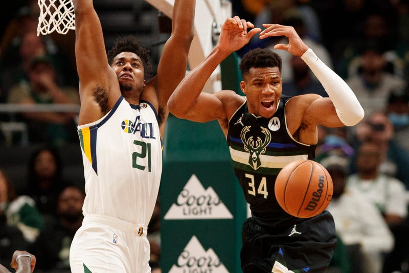 Oct 31, 2021; Milwaukee, Wisconsin, USA; Milwaukee Bucks forward Giannis Antetokounmpo (34) loses the ball under pressure from Utah Jazz center Hassan Whiteside (21) during the fourth quarter at Fiserv Forum. Mandatory Credit: Jeff Hanisch-USA TODAY Sports