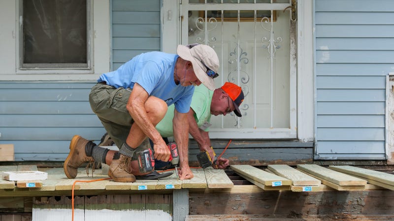 Two volunteers working on a new porch for a family in Buffalo's Lovejoy District