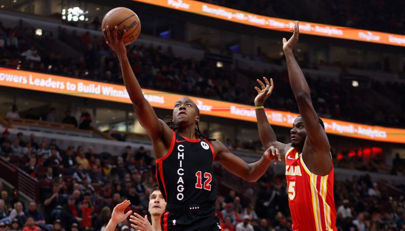 Bulls guard Ayo Dosunmu (12) goes to the basket against the Hawks.
