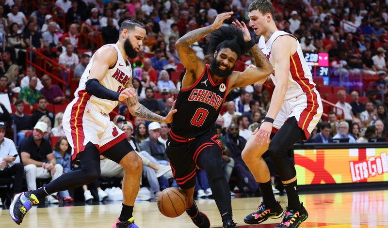 Bulls guard Coby White (0) reacts after driving to the basket against Miami Heat forward Caleb Martin (16) and forward Nikola Jovic (5).