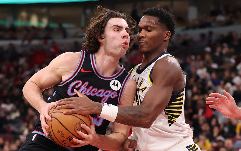 Bulls guard Josh Giddey, left, drives to the hoop against Pacers guard Bennedict Mathurin.